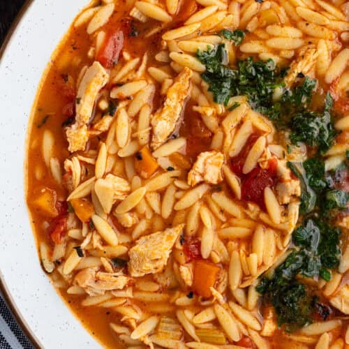 A bowl of turkey orzo soup with gremolata.