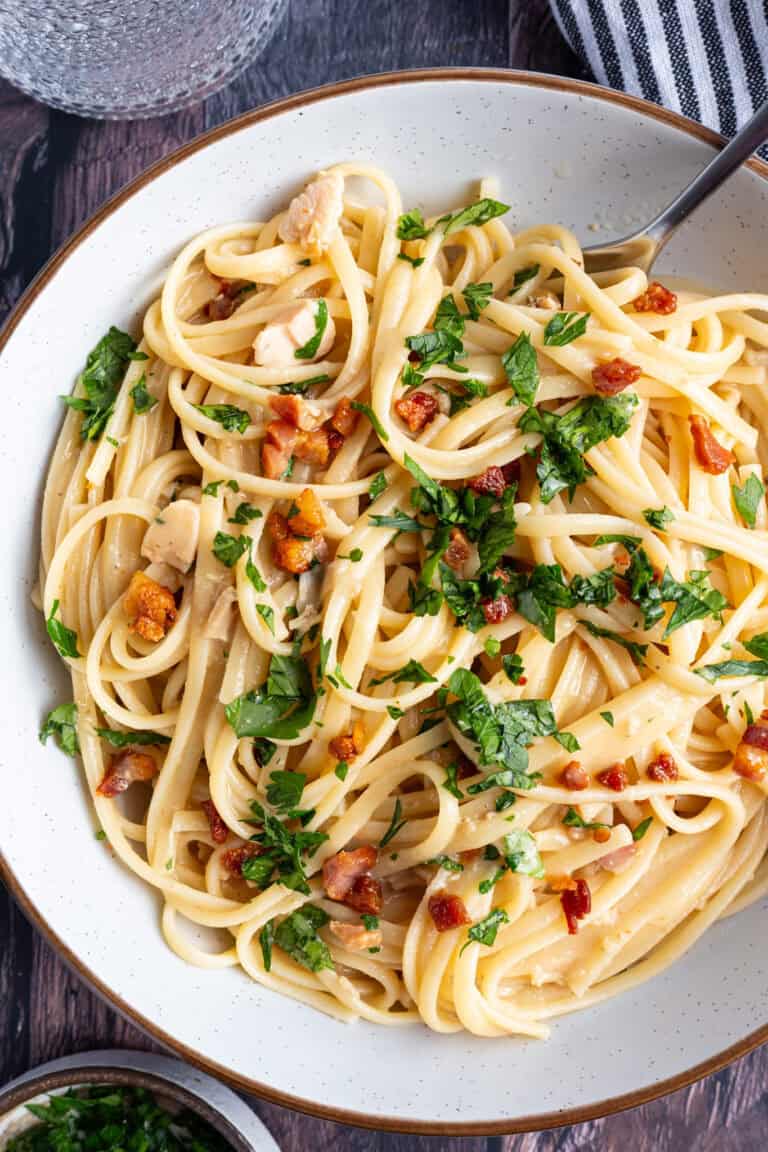 A bowl of pasta with crispy pancetta.