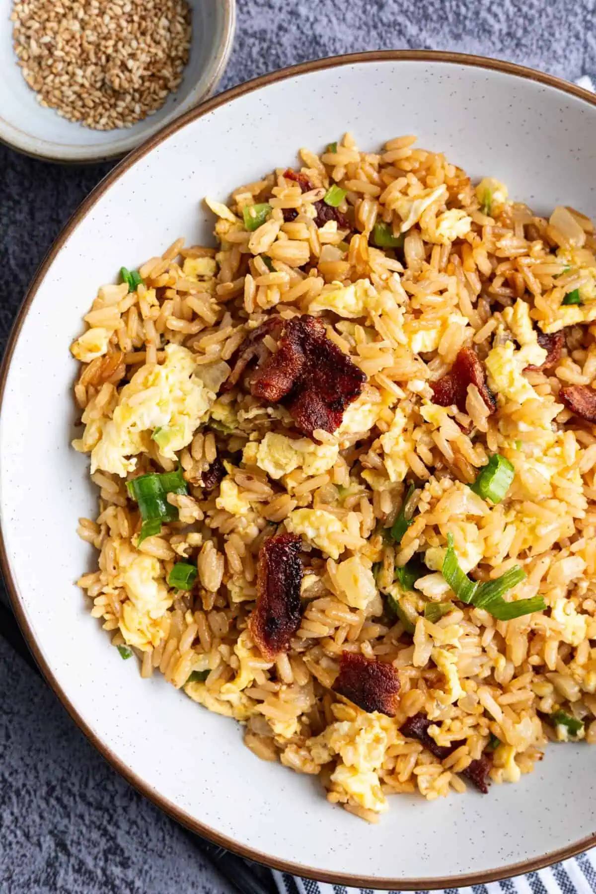 A bowl of bacon and egg fried rice.