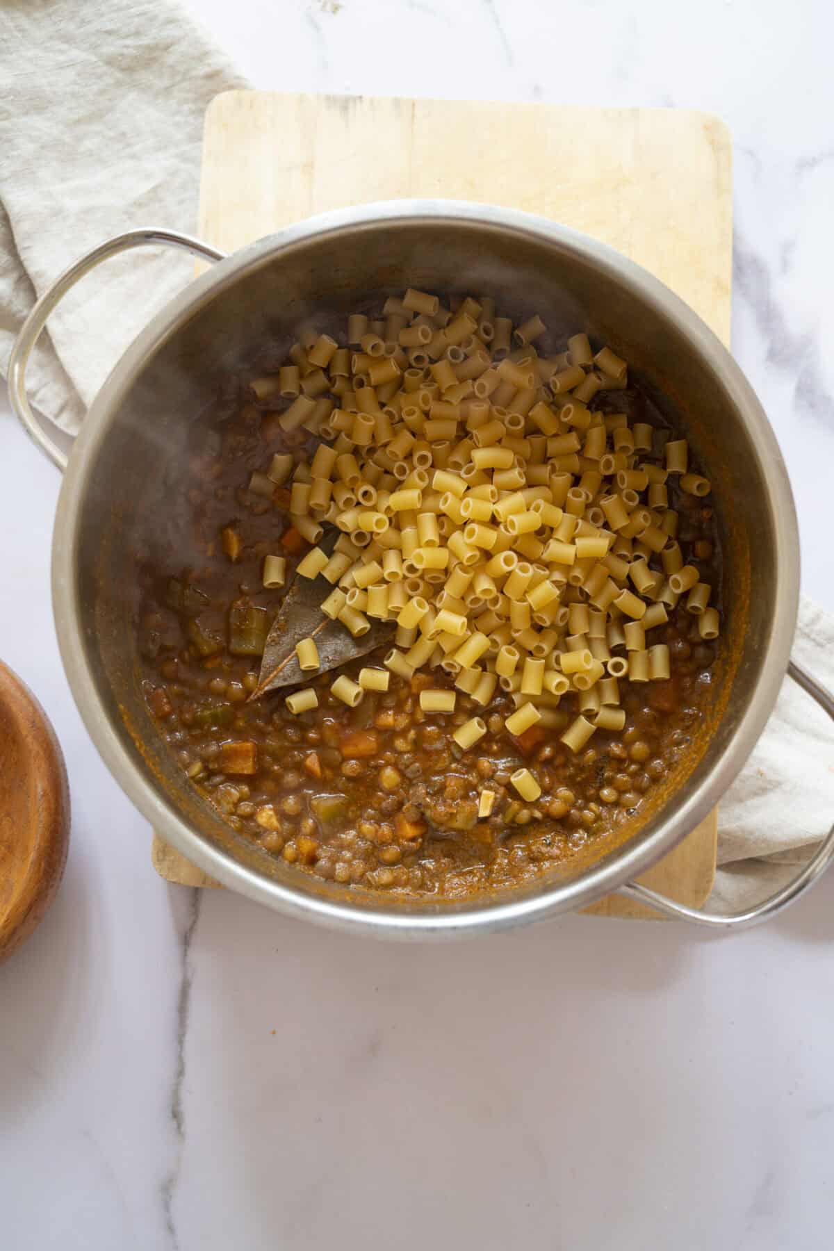 A pot of soup with lentils and pasta.