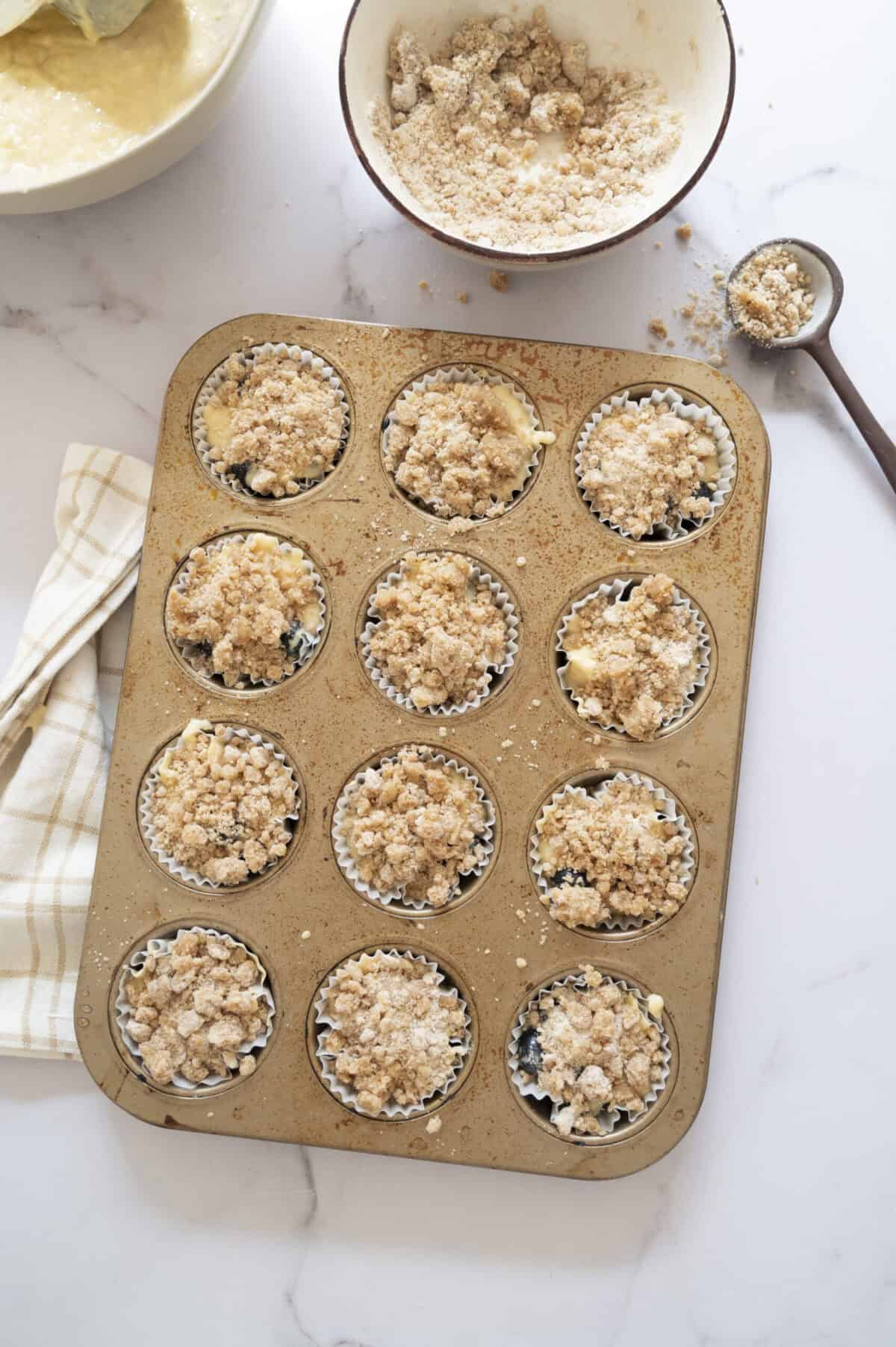 Muffin batter topped with streusel.