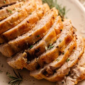 A platter of sliced, golden turkey breast.