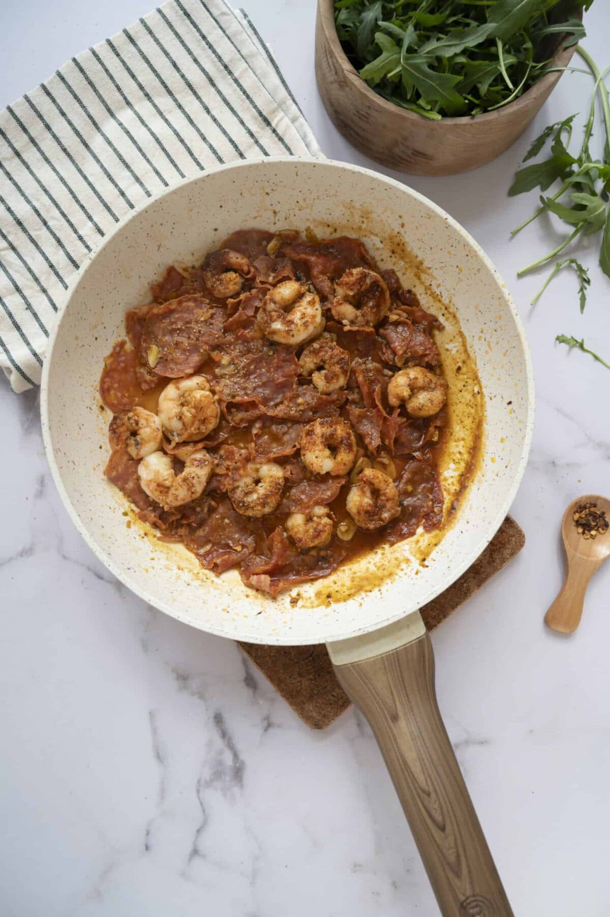A pan of cooked chorizo and shrimp.