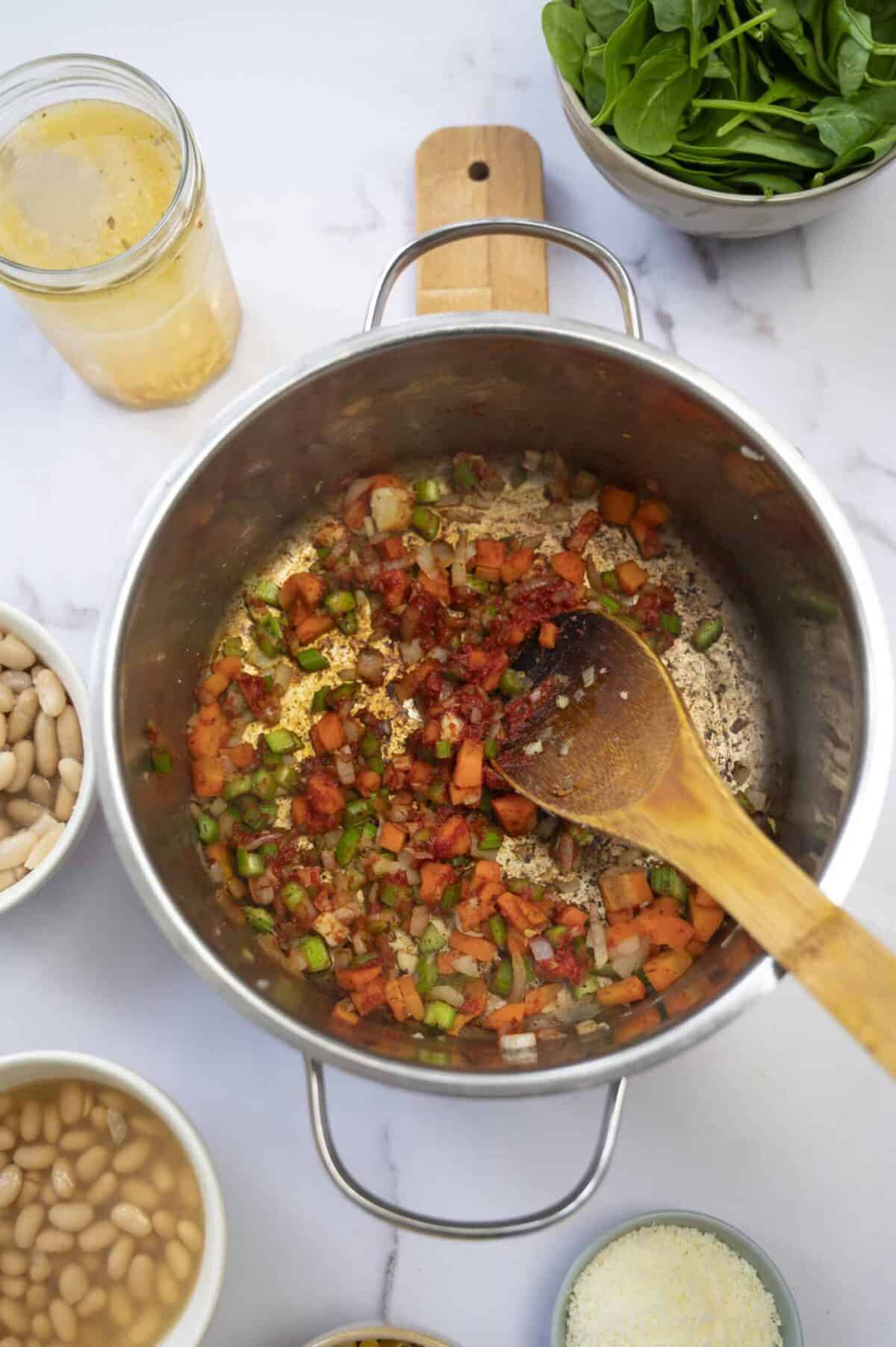 A pot of cooked celery, carrot, onion, and tomato paste.