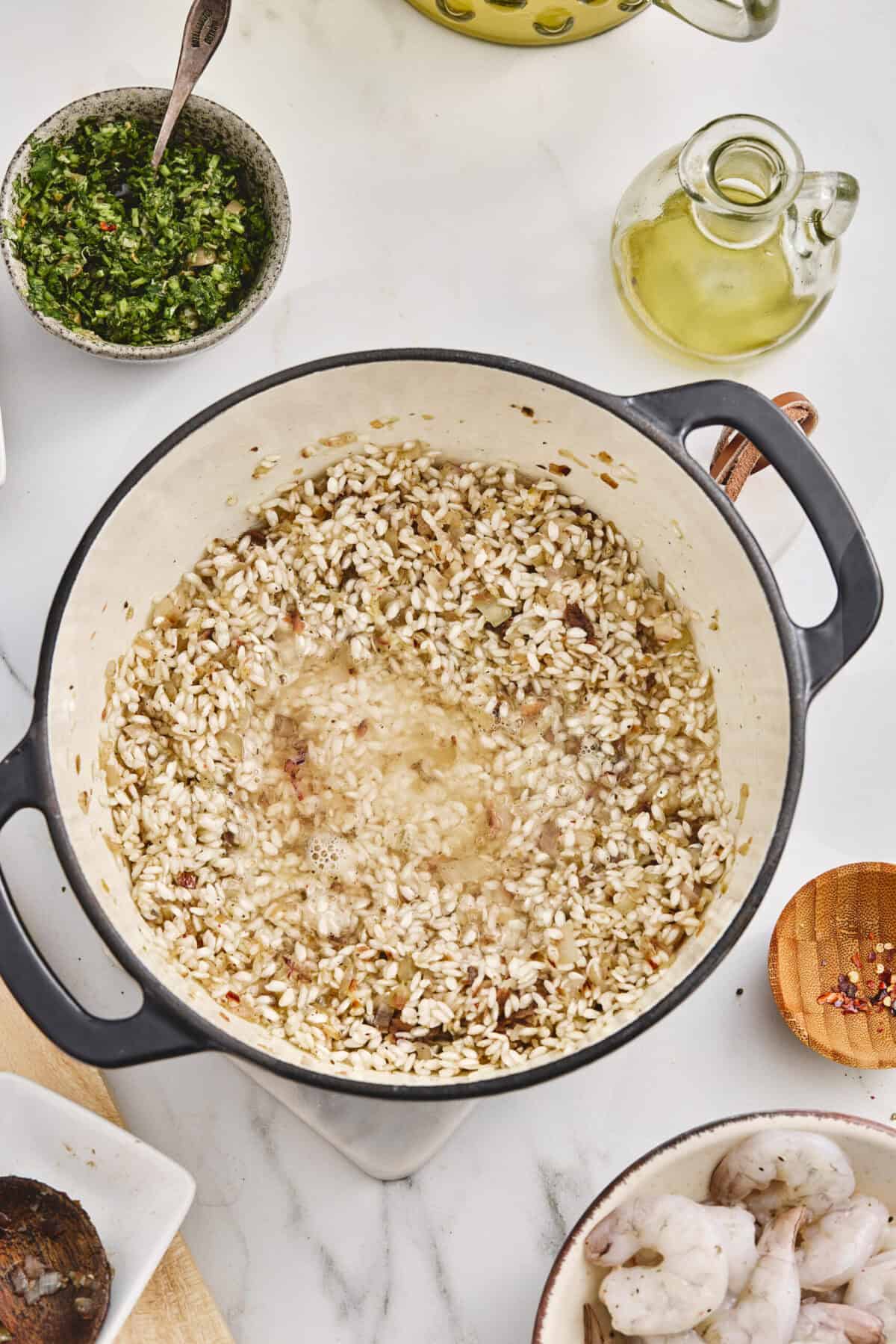 A pot of rice simmering with some white wine.