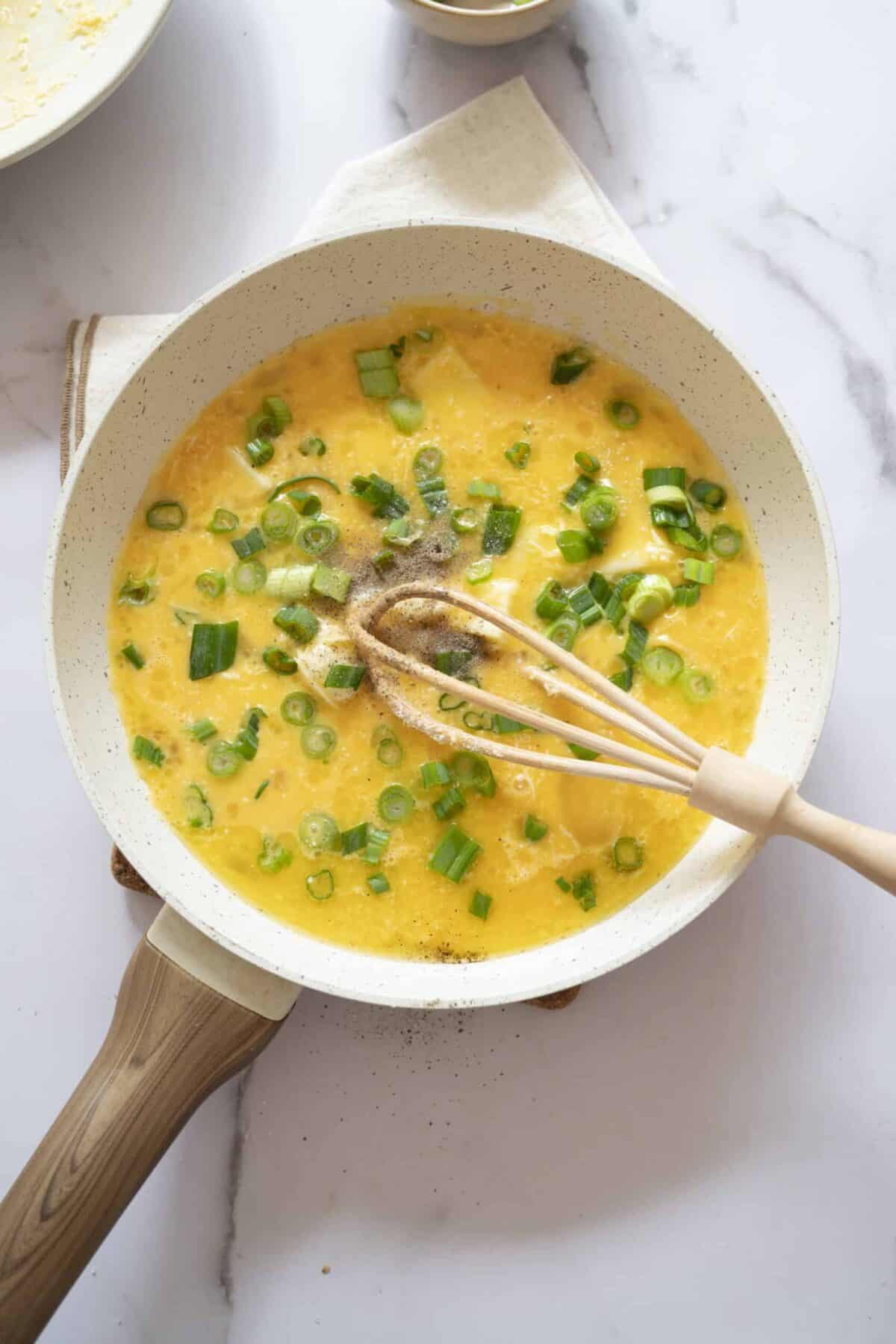 A pan of eggs with melted mozzarella.