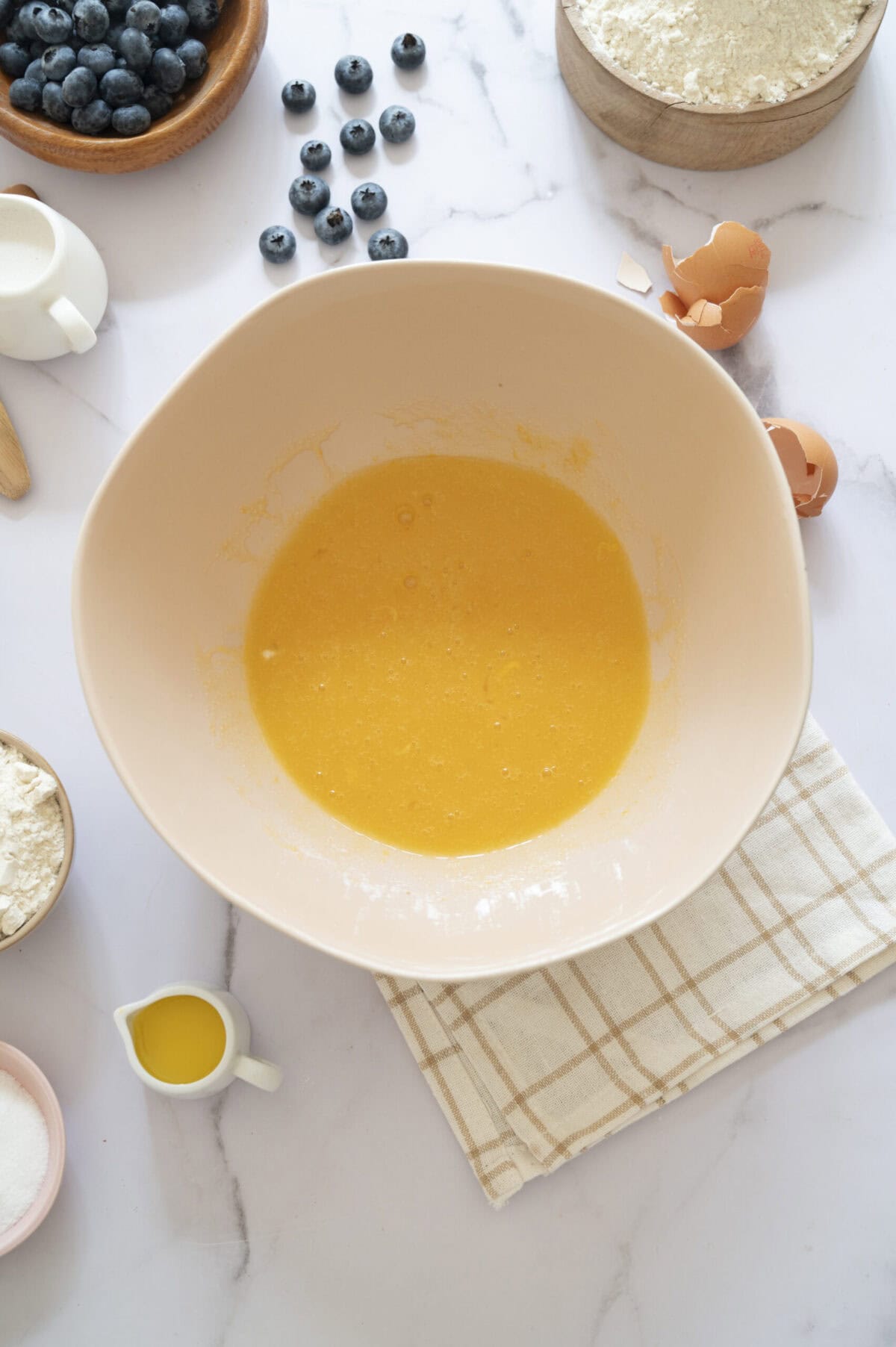 Eggs whisked with sugar, butter, and oil.