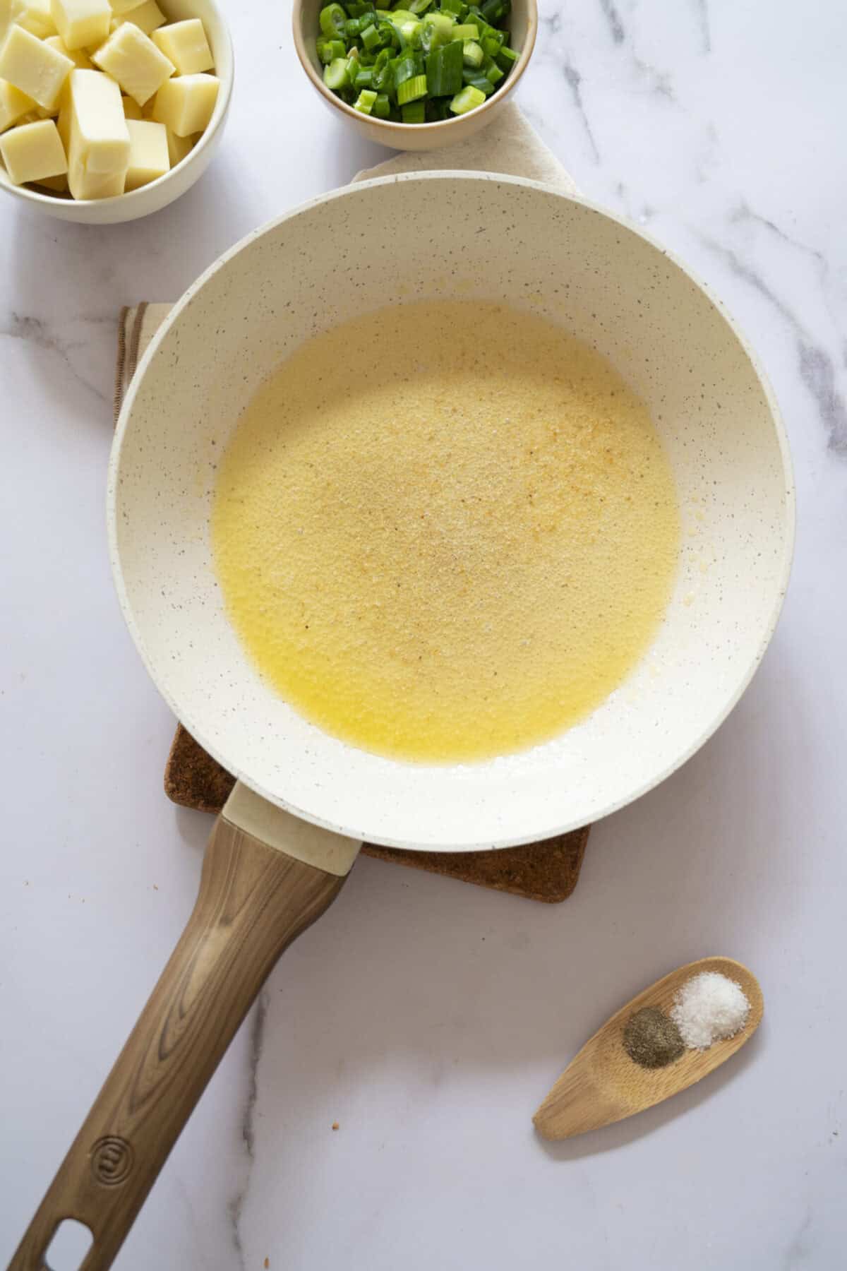 A pan of melted butter and garlic powder.