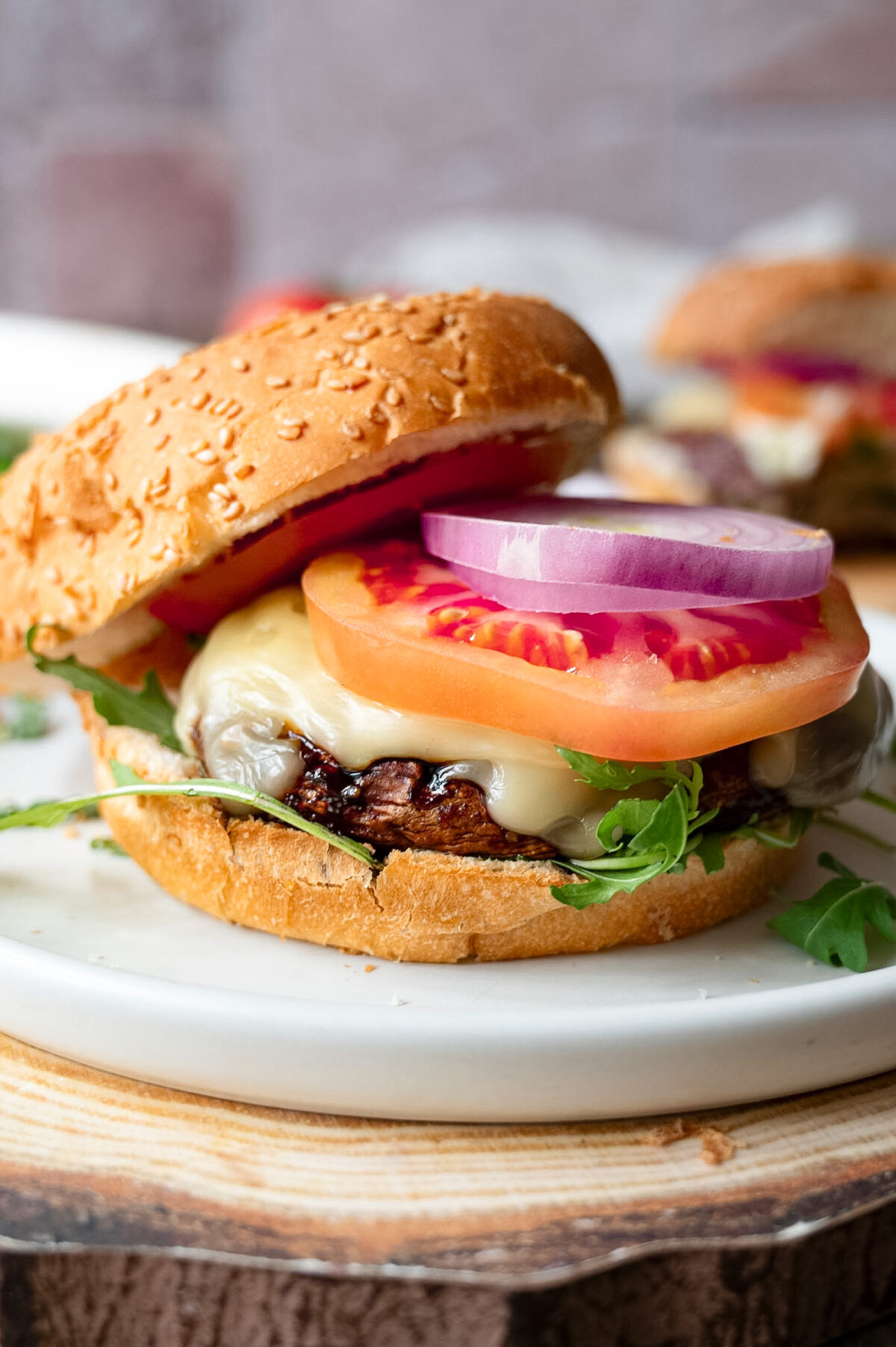 A mushroom burger topped with cheese and tomato.