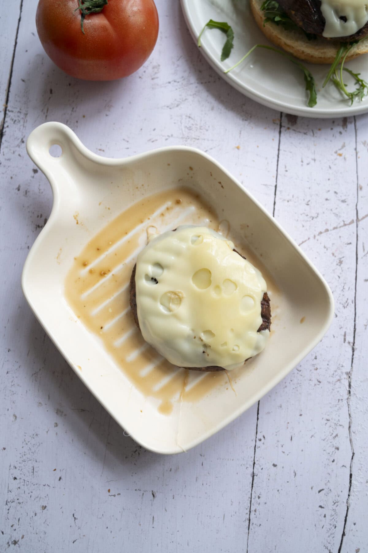 Melted cheese on a portobello burger.