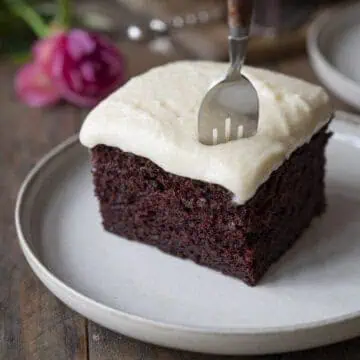 A fork inserted into a piece of chocolate cake.