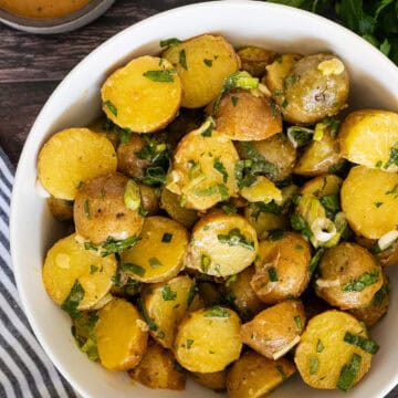 A bowl of herby potato salad.