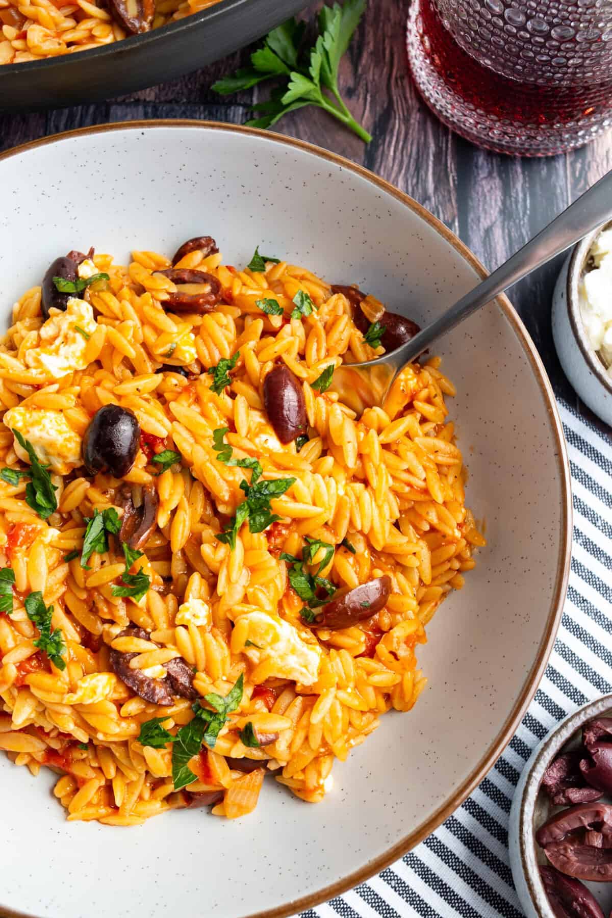 A bowl of orzo with feta and olives.