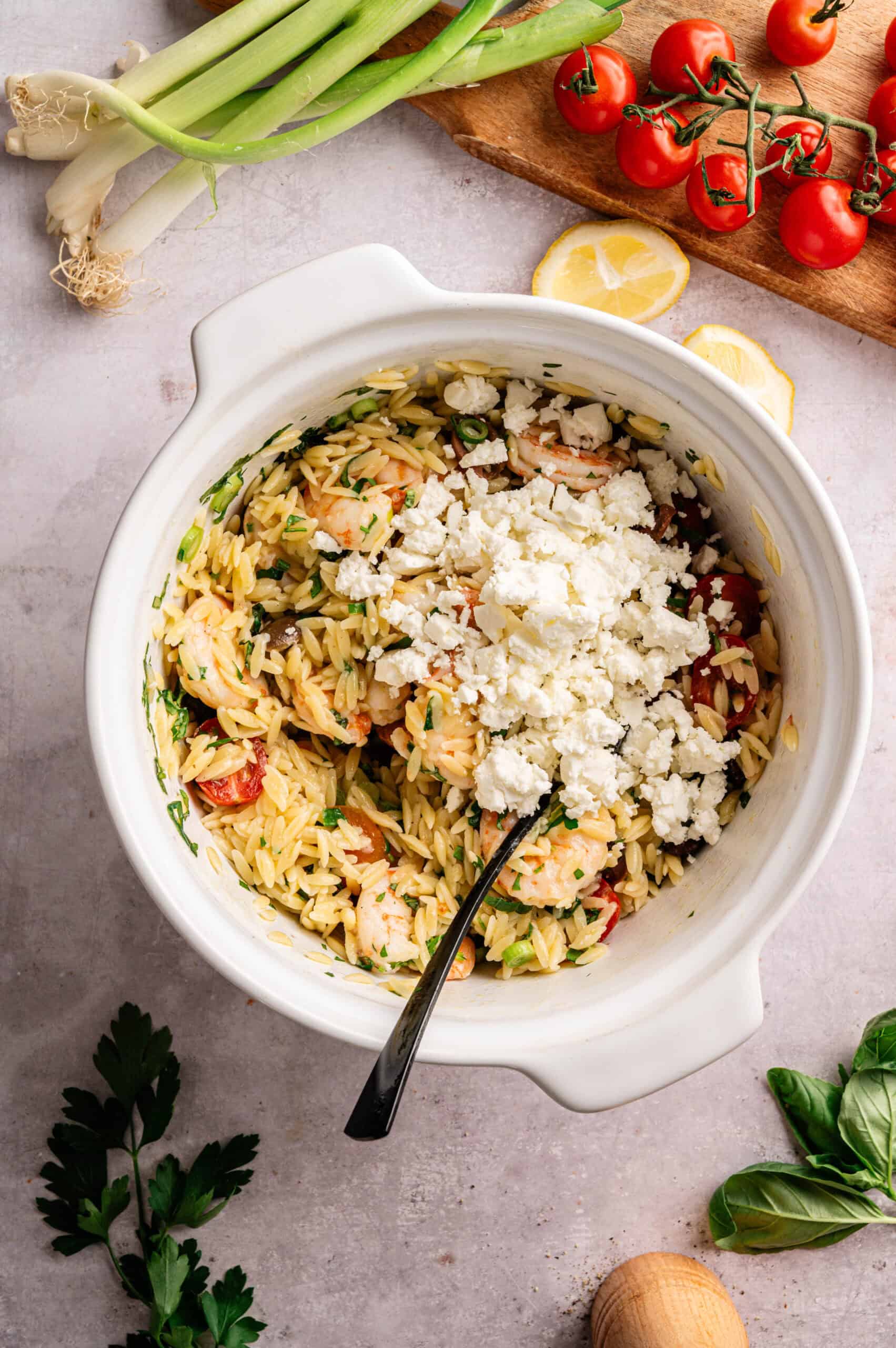 A bowl of orzo salad with feta.