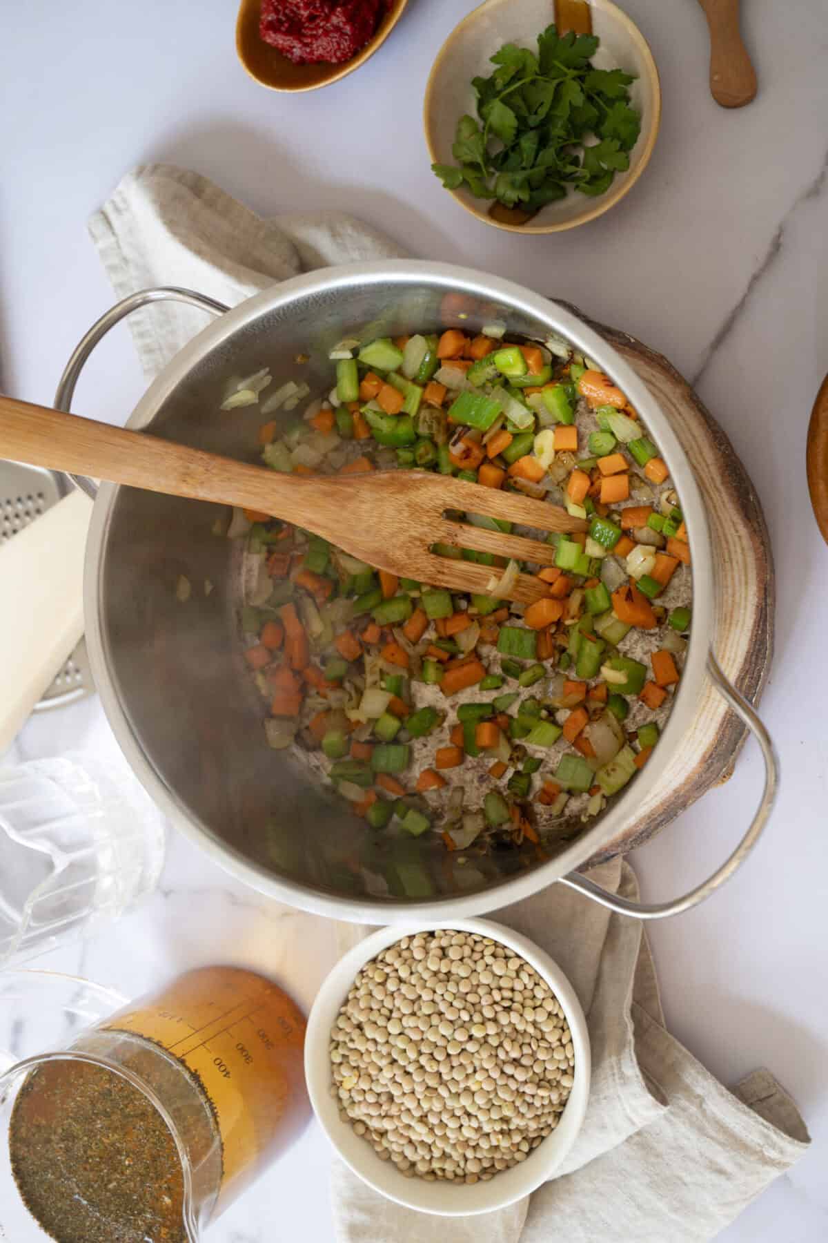 A pot of sauteed onions, celery, and carrots.
