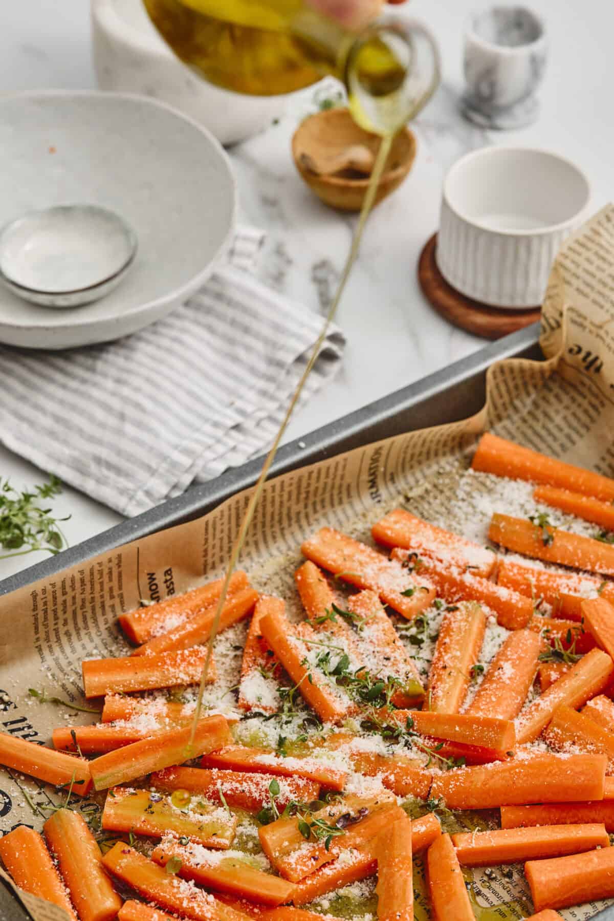 A pan of seasoned carrots before being roasted.