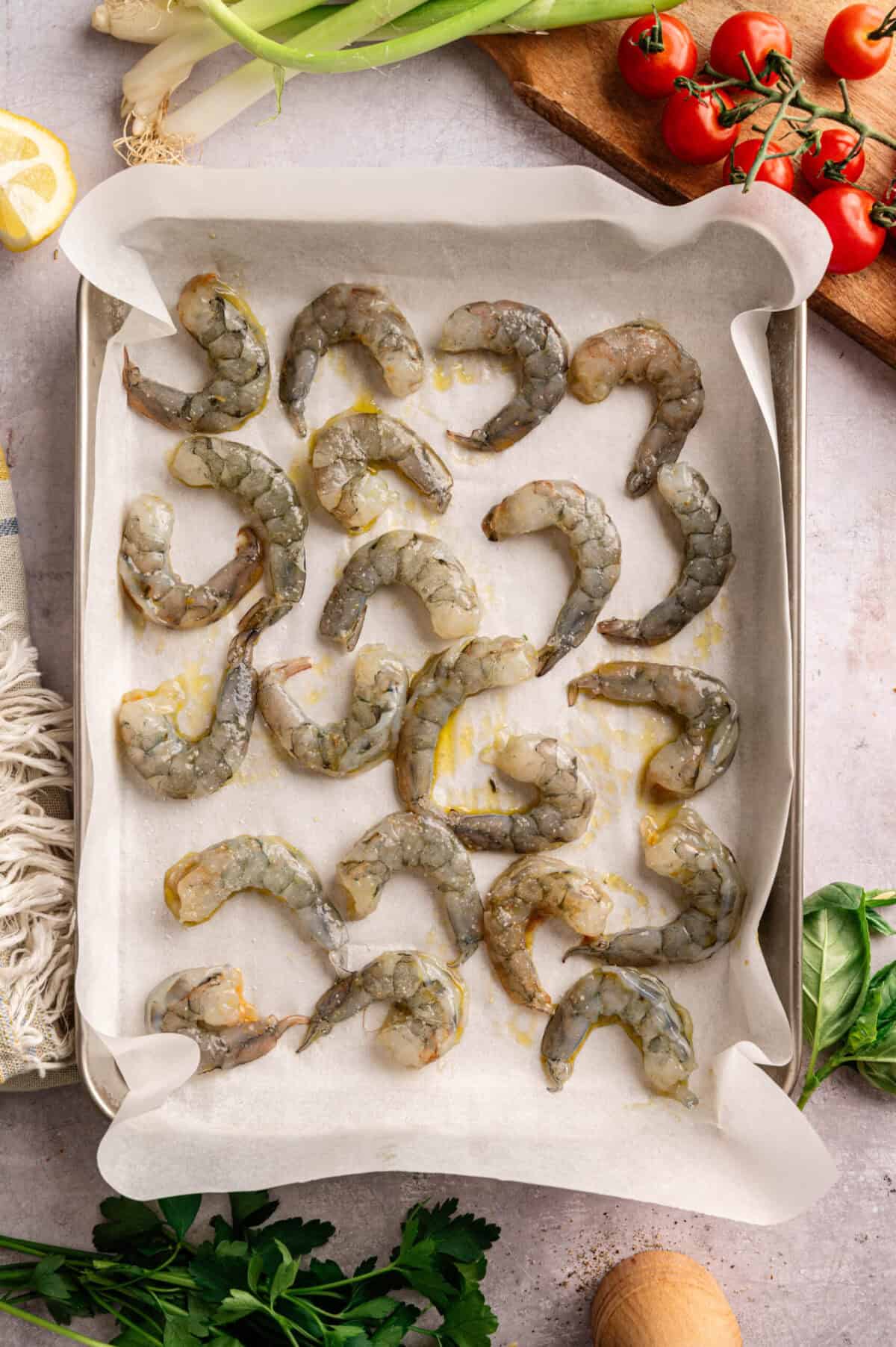 A pan of raw seasoned shrimp.