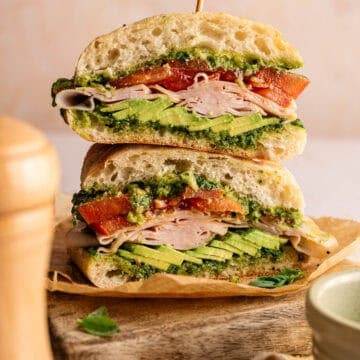 A sliced and stacked smoked turkey sandwich.