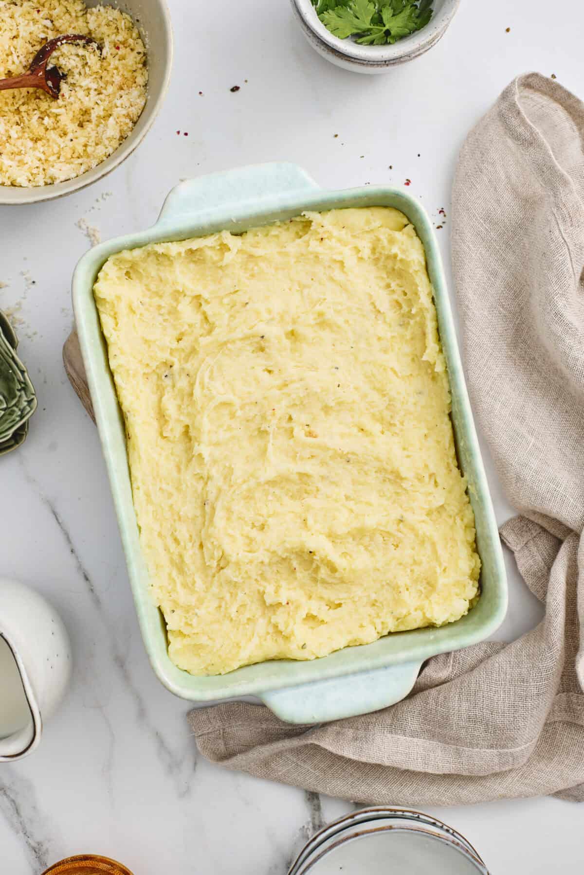 A casserole dish of smooth Italian mashed potatoes.
