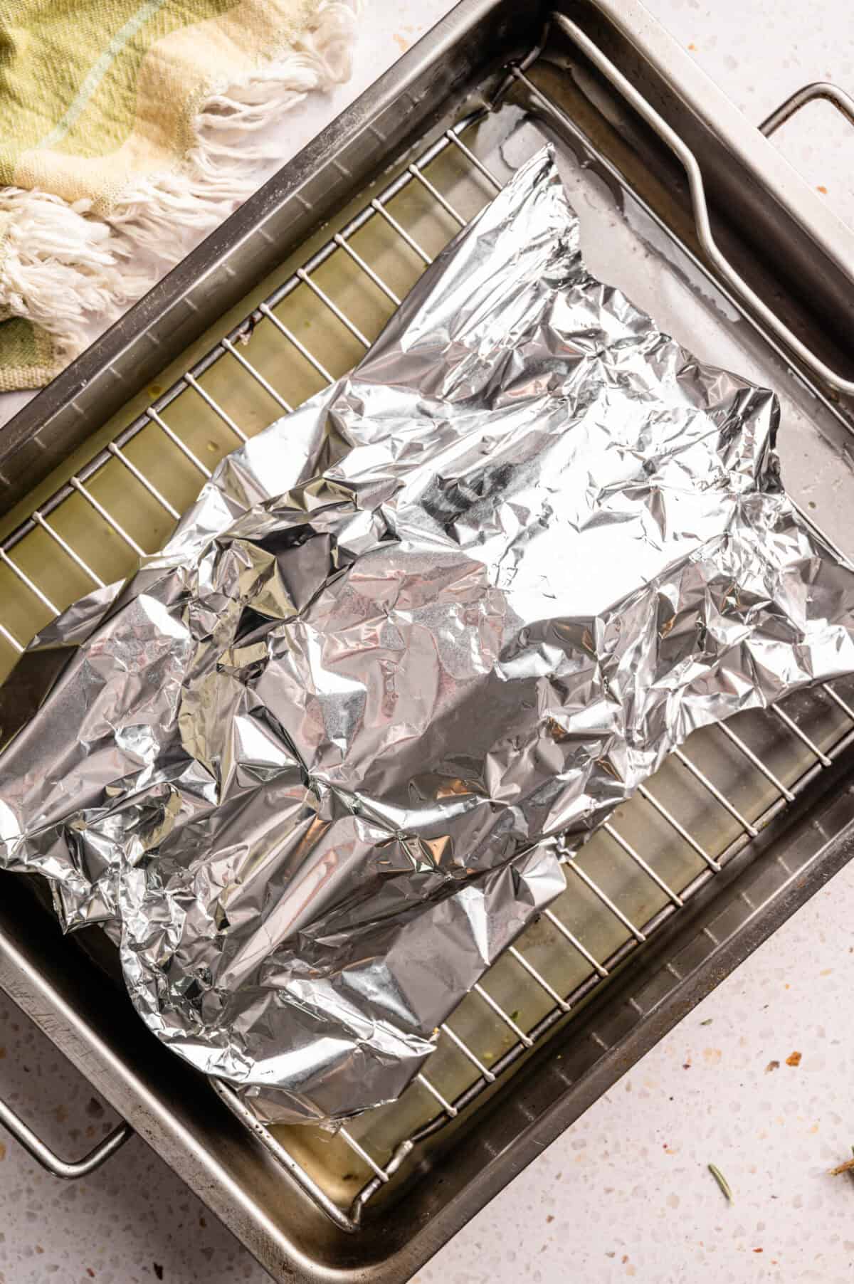 Turkey breast covered in foil.