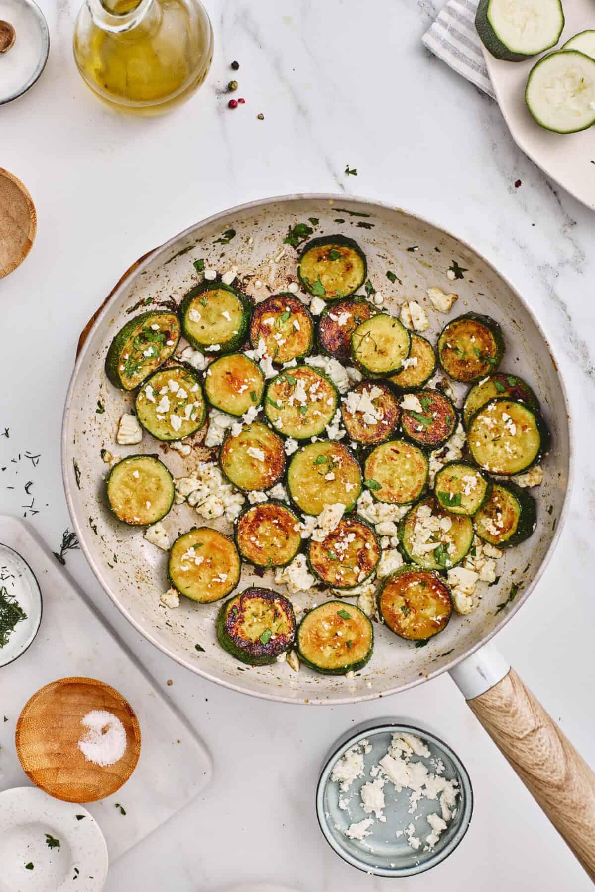 A pan of cooked zucchini with feta.