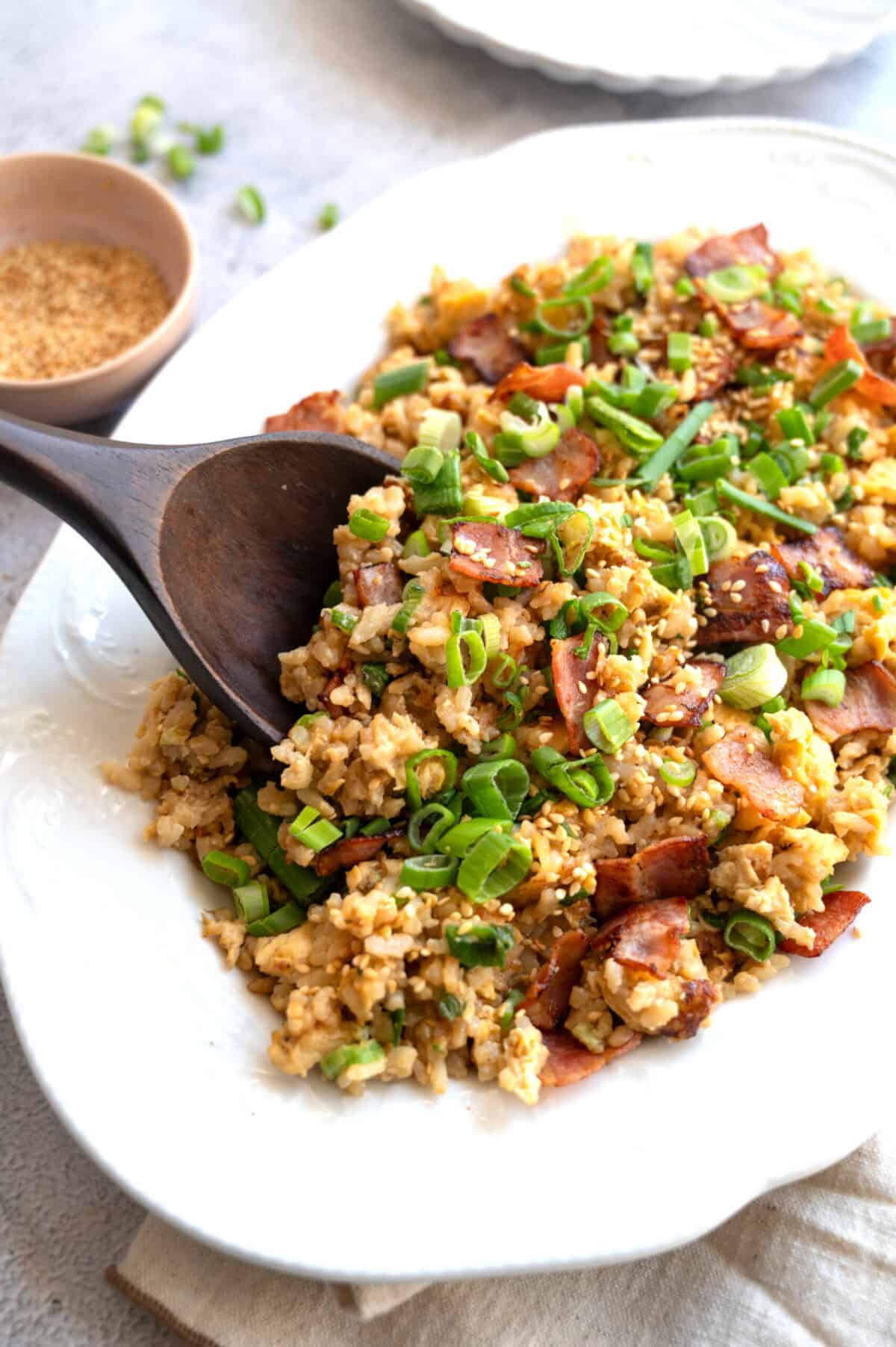 A platter of bacon and egg fried rice.
