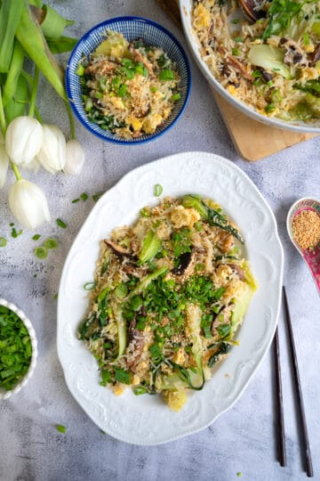 Bok choy fried rice garnished with scallions and toasted sesame seeds.