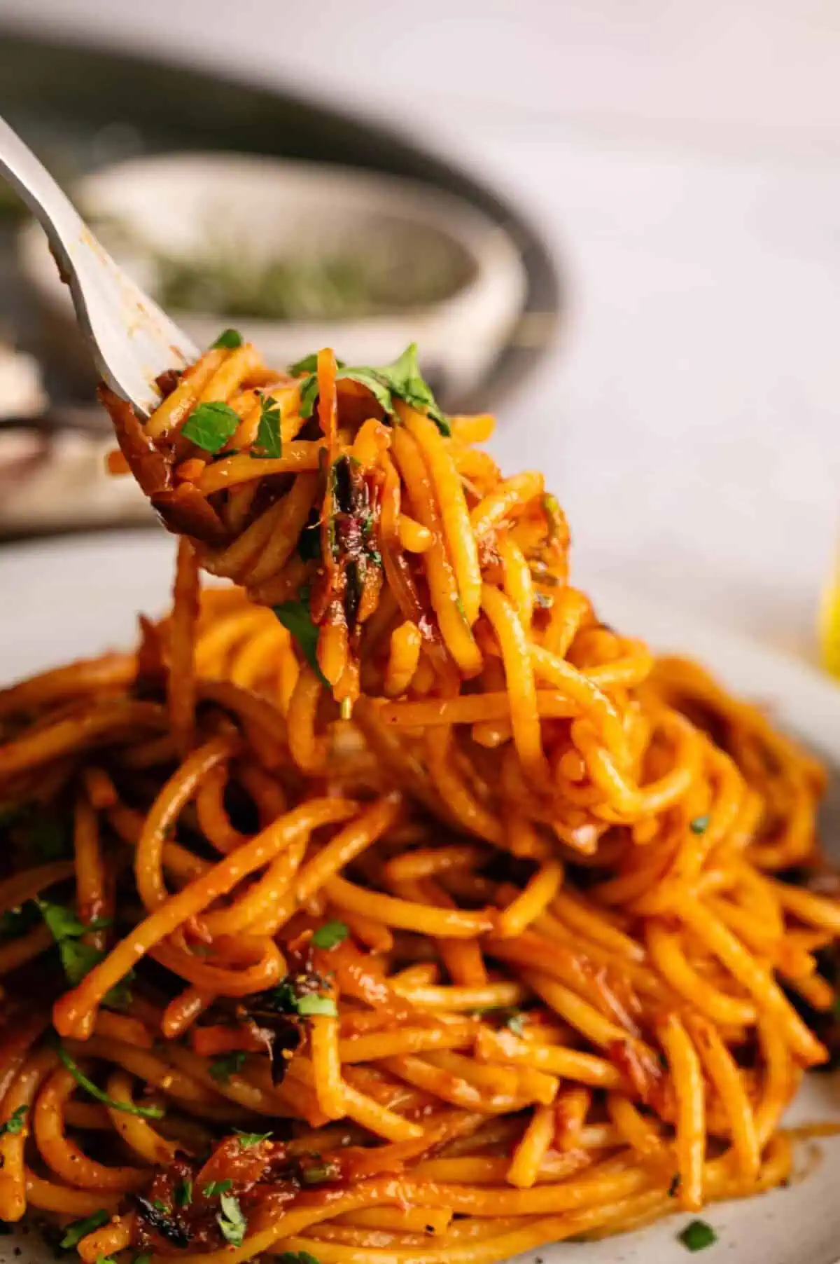Caramelized shallot pasta twirled around a fork.