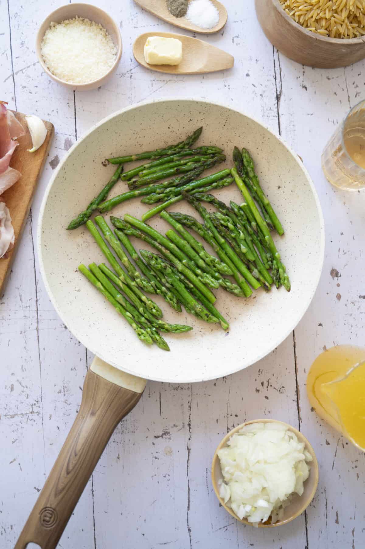 A pan of sauteed asparagus spears.