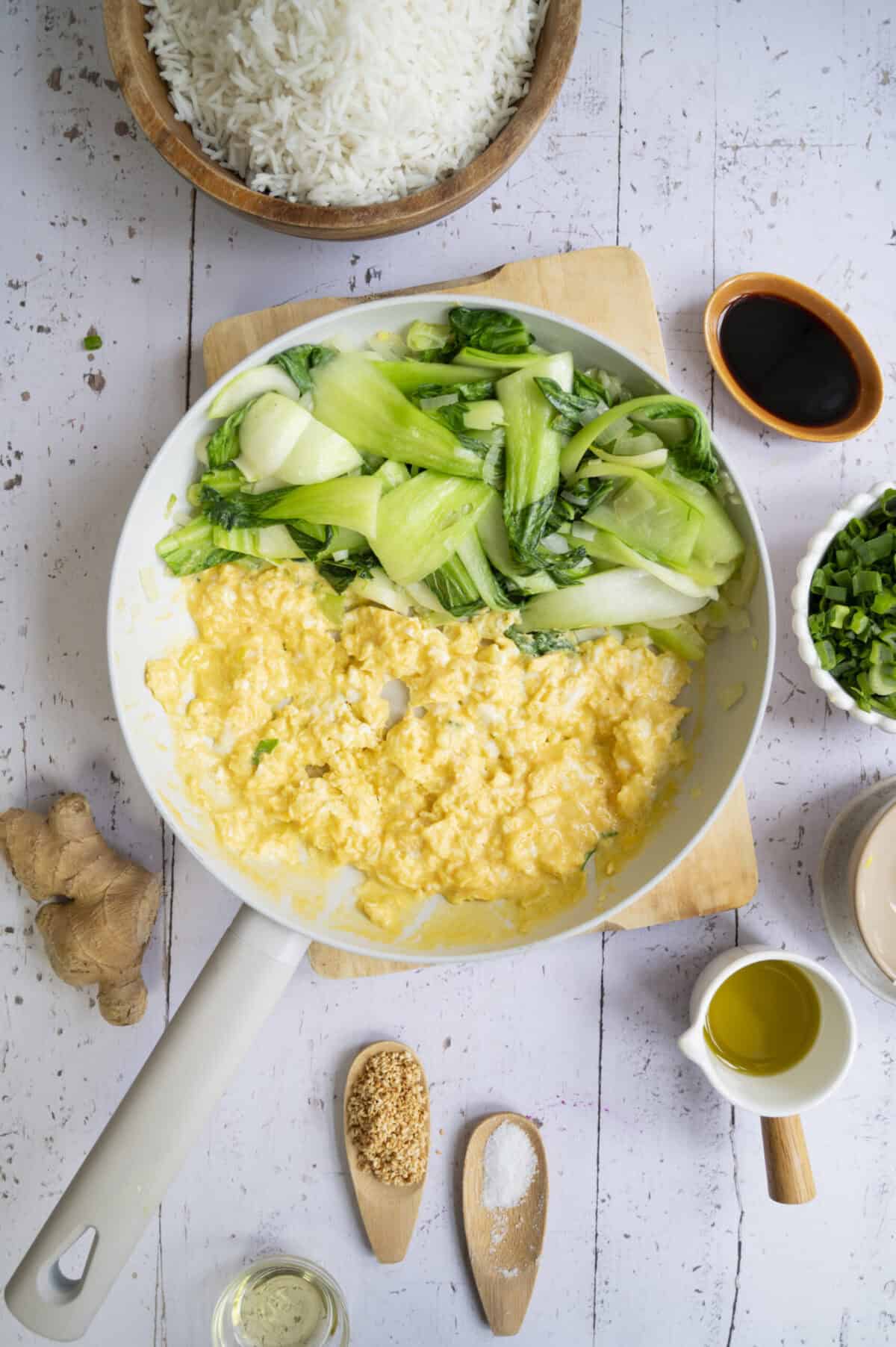 A pan of cooked bok choy and scrambled eggs.
