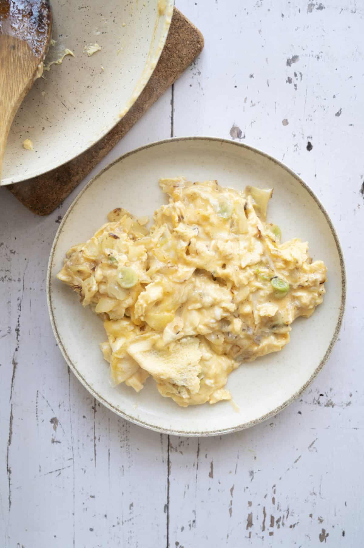 A plate of scrambled eggs.