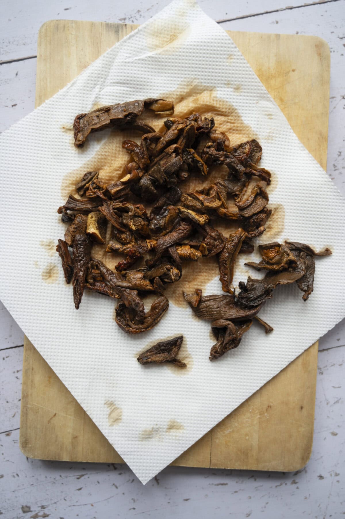 Soaked porcini mushrooms draining on a paper towel.