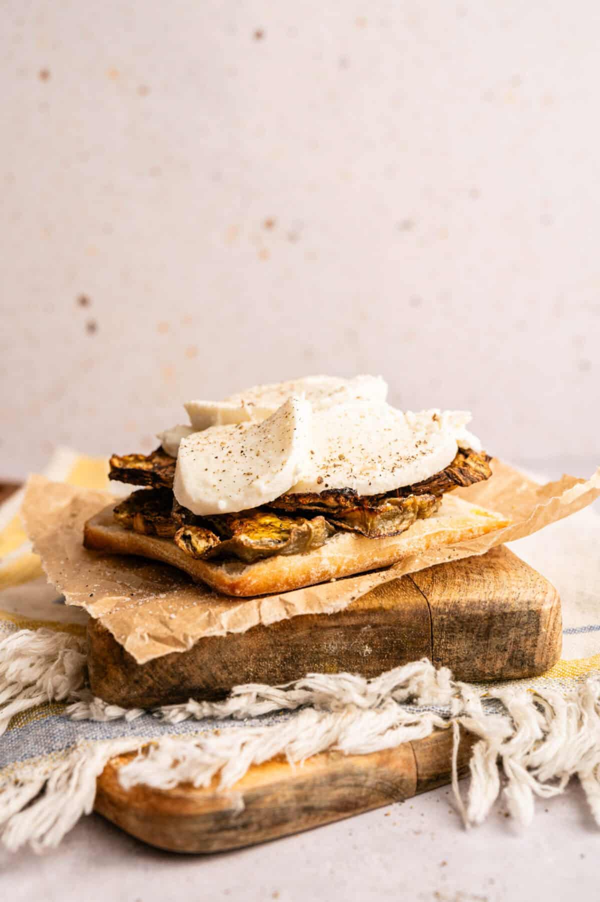 Mozzarella and eggplant on the bottom half of ciabatta bread.