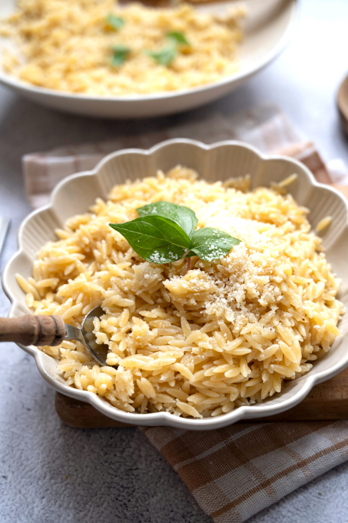 A bowl of lemon orzo topped with basil and Pecorino.