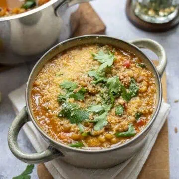 A bowl of lentil and barley soup topped with Pecorino.