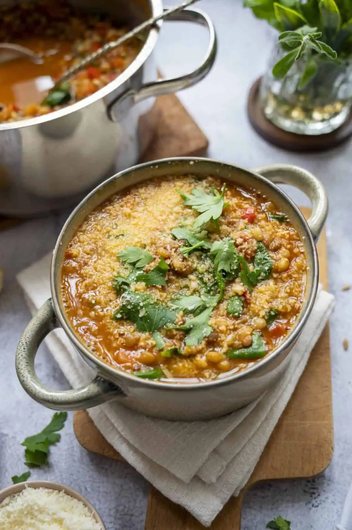 A bowl of lentil and barley soup topped with Pecorino.