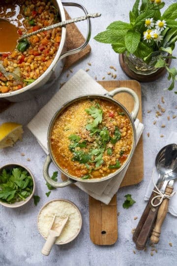 A bowl of lentil and barley soup with fire-roasted tomatoes.