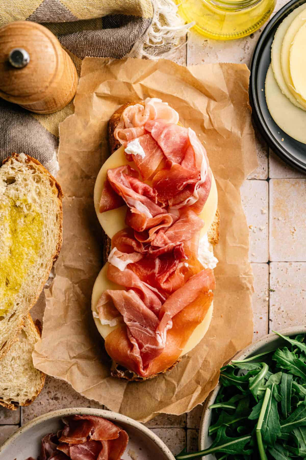 A slice of bread topped with prosciutto.