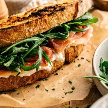 A panini stuffed with cheese and prosciutto.