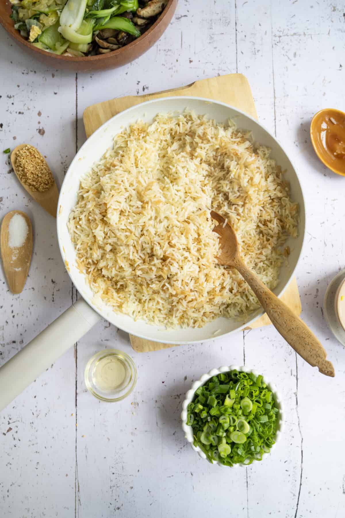 A pan of cooked jasmine rice with soy sauce.