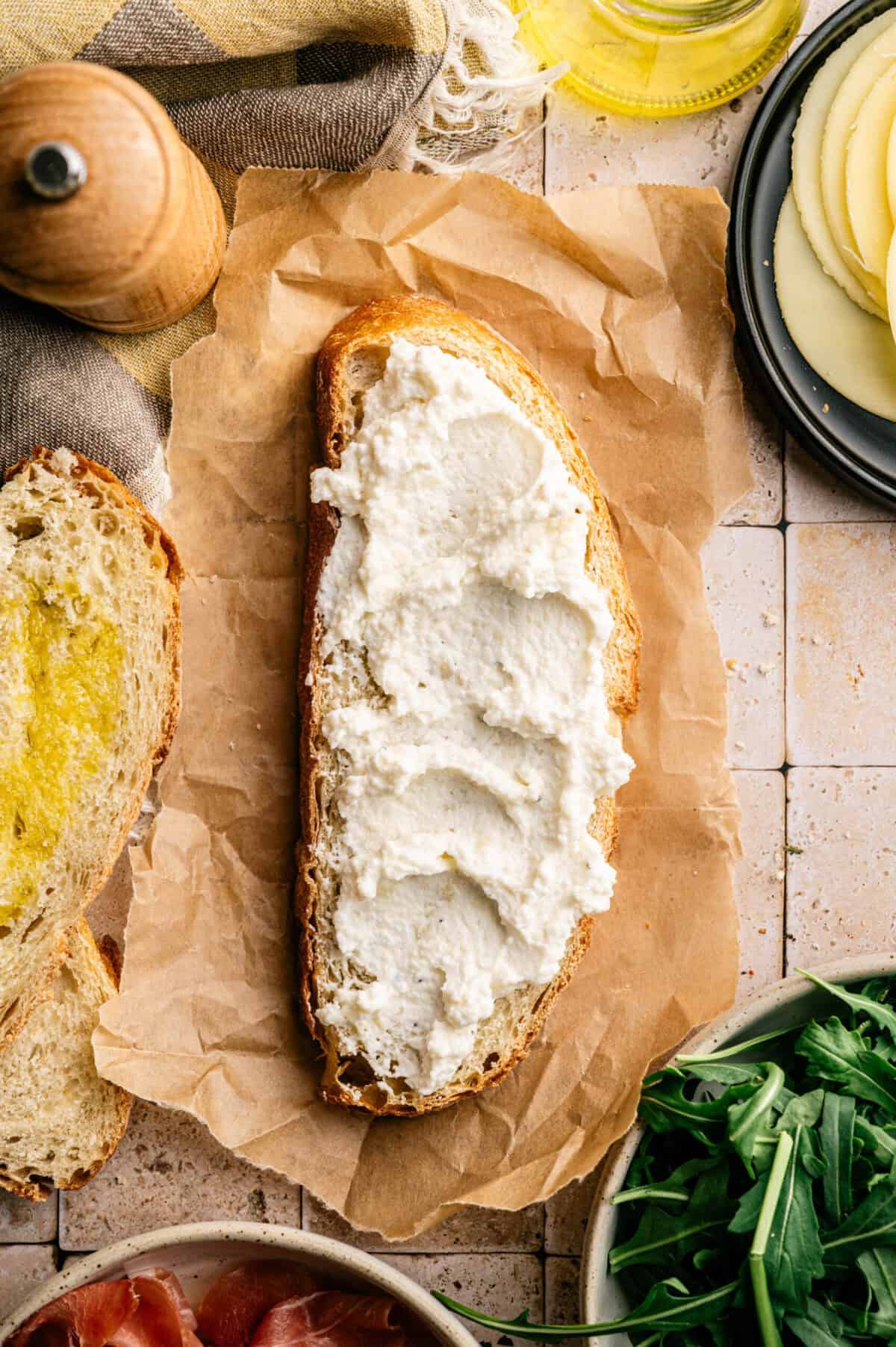 A slice of bread smeared with whipped ricotta.