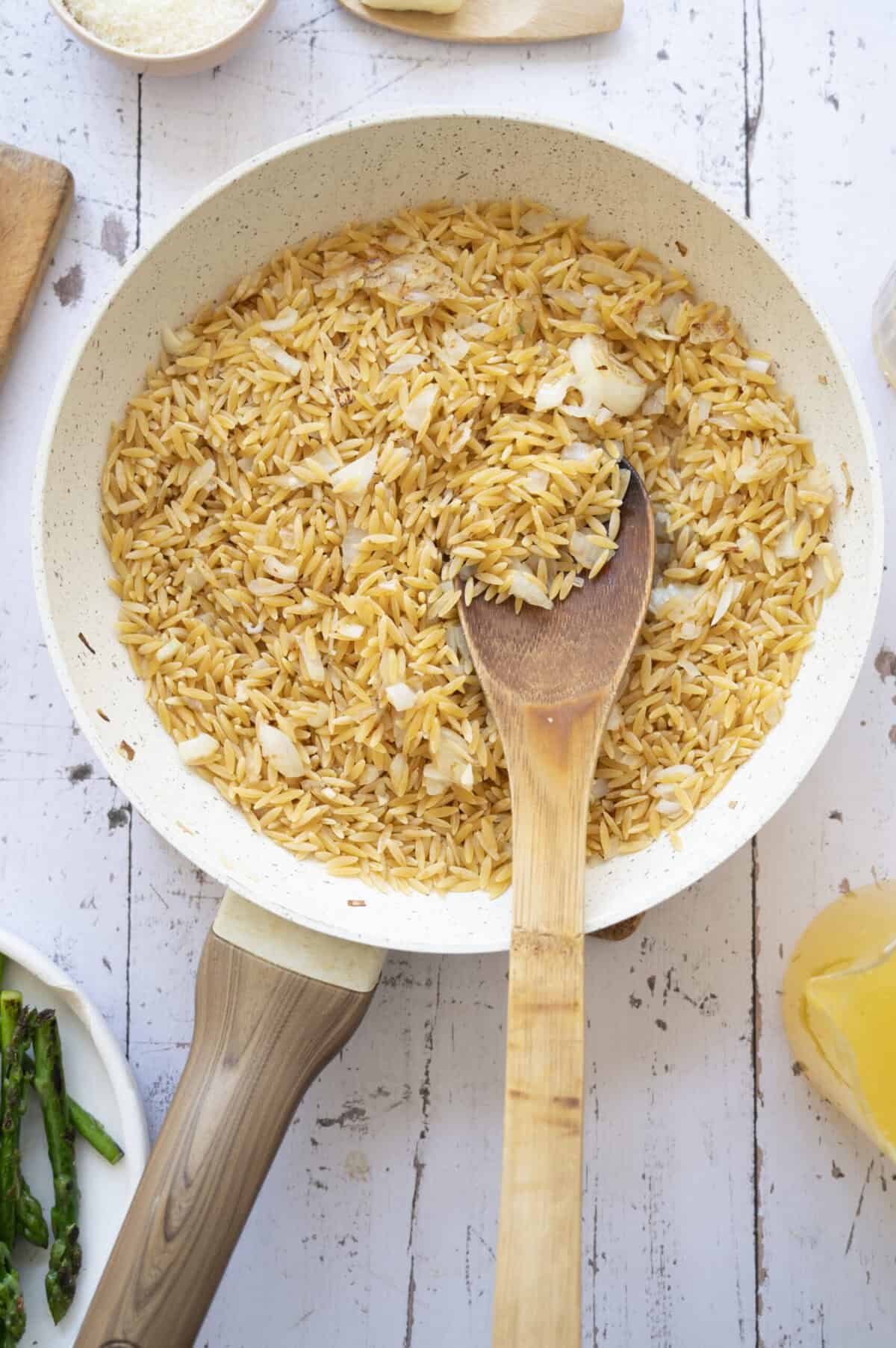 A pan of toasted orzo.
