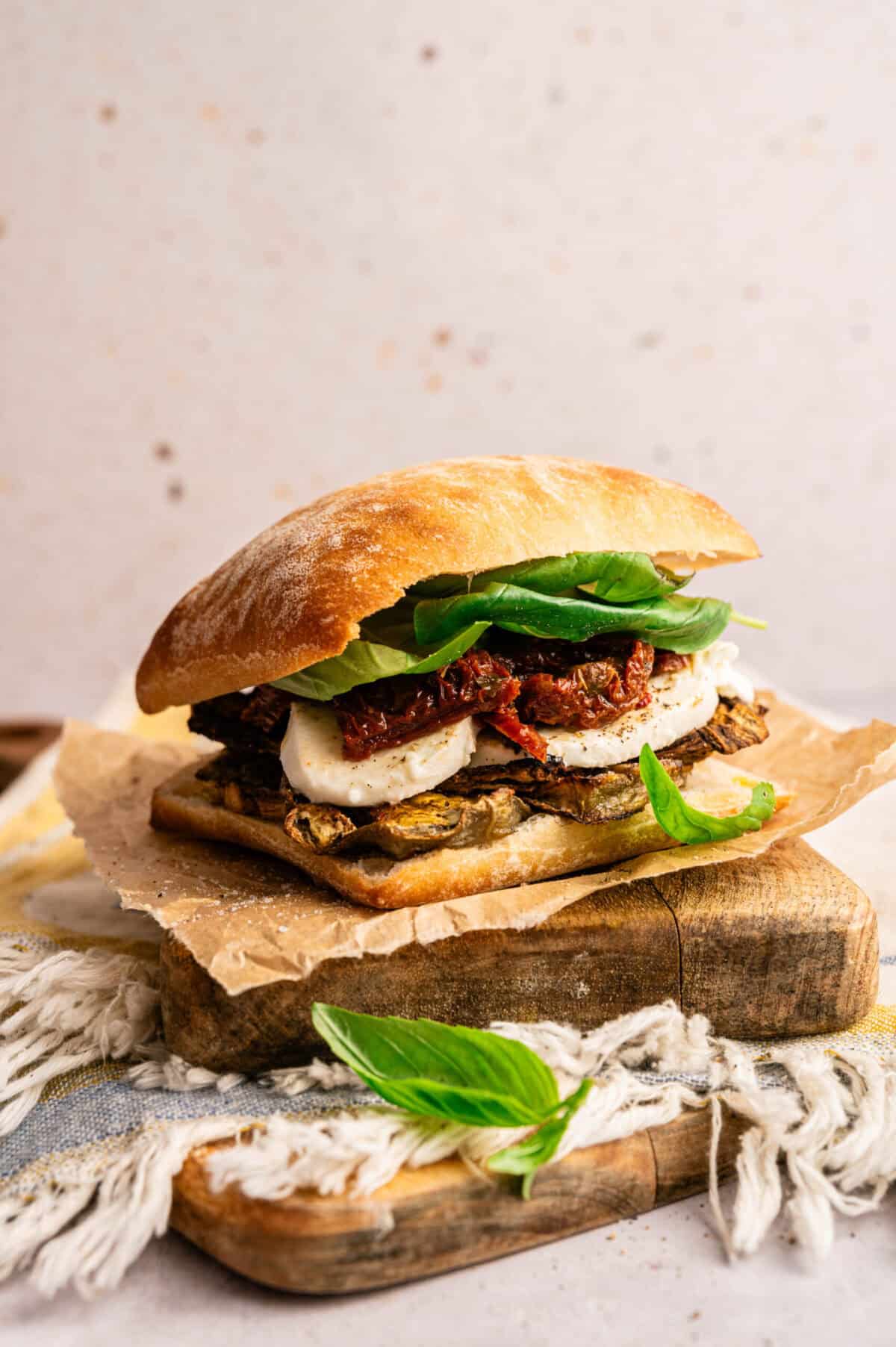 An assembled roasted eggplant sandwich on ciabatta.