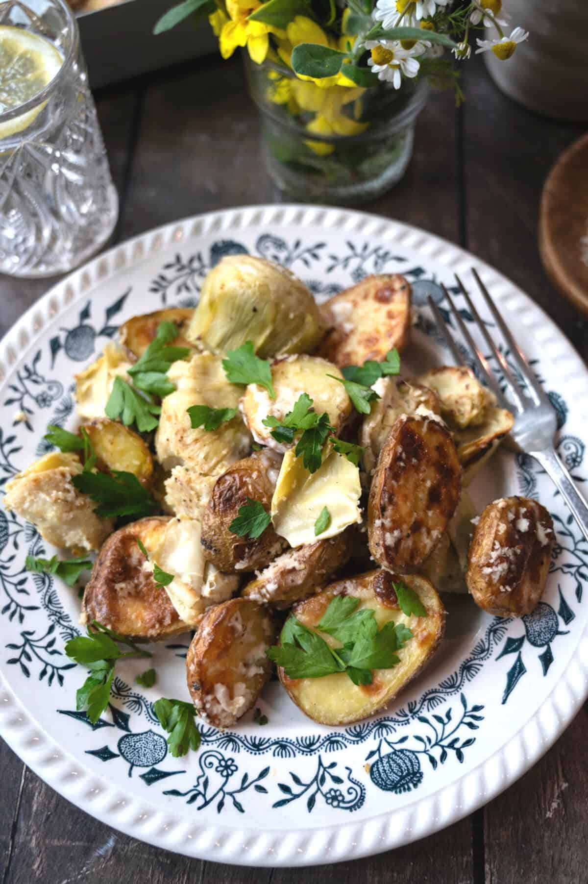 A plate of artichoke hearts and potatoes with heavy cream.