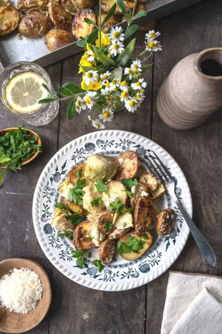 Creamy artichokes and potatoes garnished with parsley.