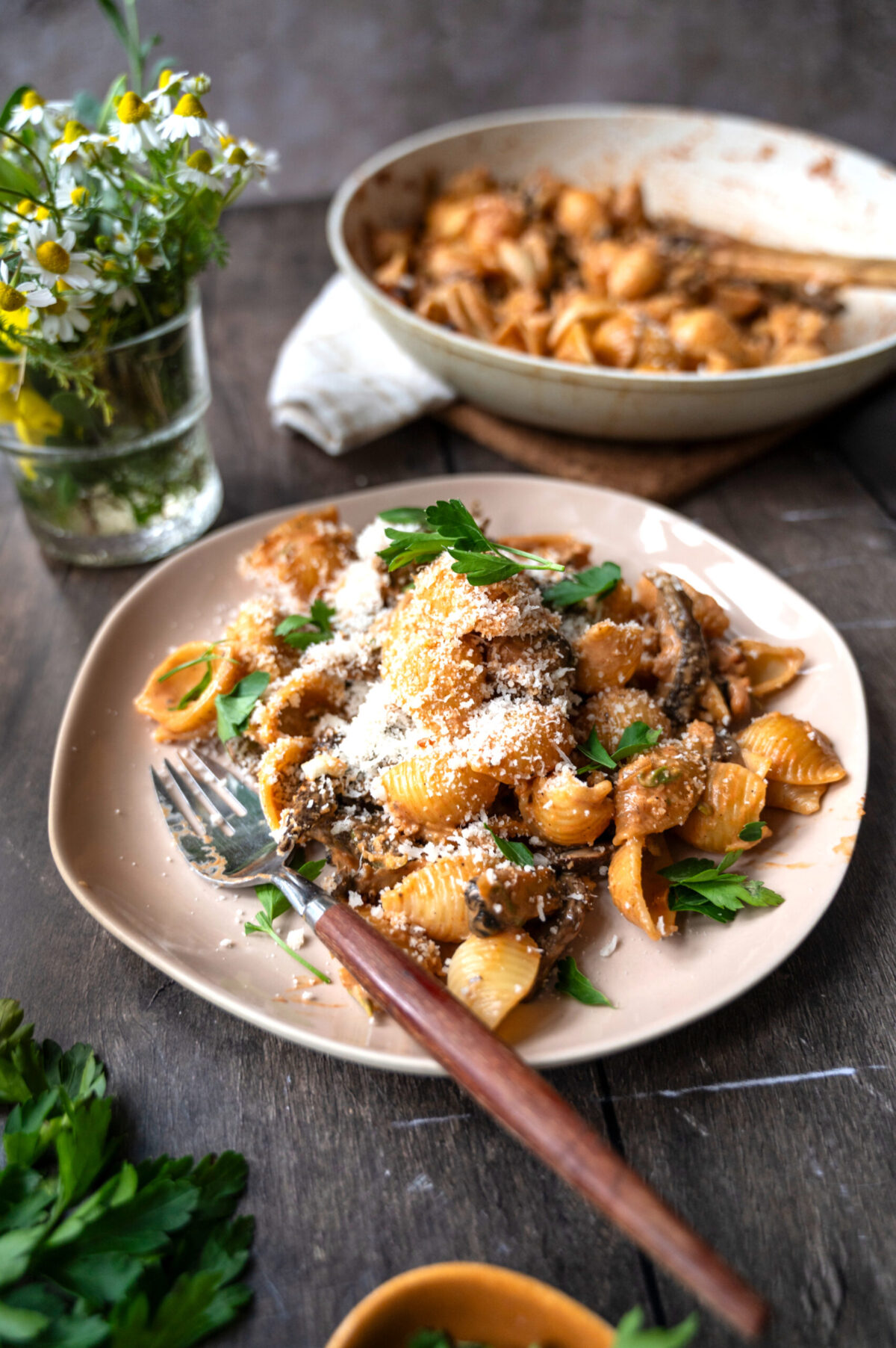 A plate of creamy shell pasta with portobello and porcini mushrooms.