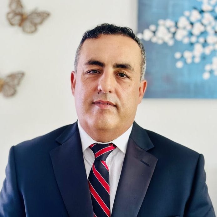 Professional portrait of a Fortitude Healthcare executive in formal suit.