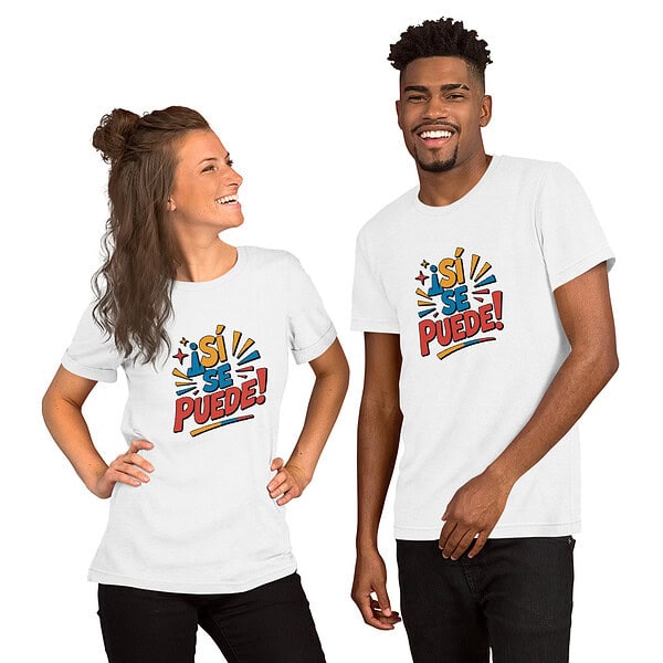 unisex-staple-t-shirt-white-front-6a372757f10ae.jpg Two diverse young adults wearing 'Sí Se Puede!' T-shirts smiling together.