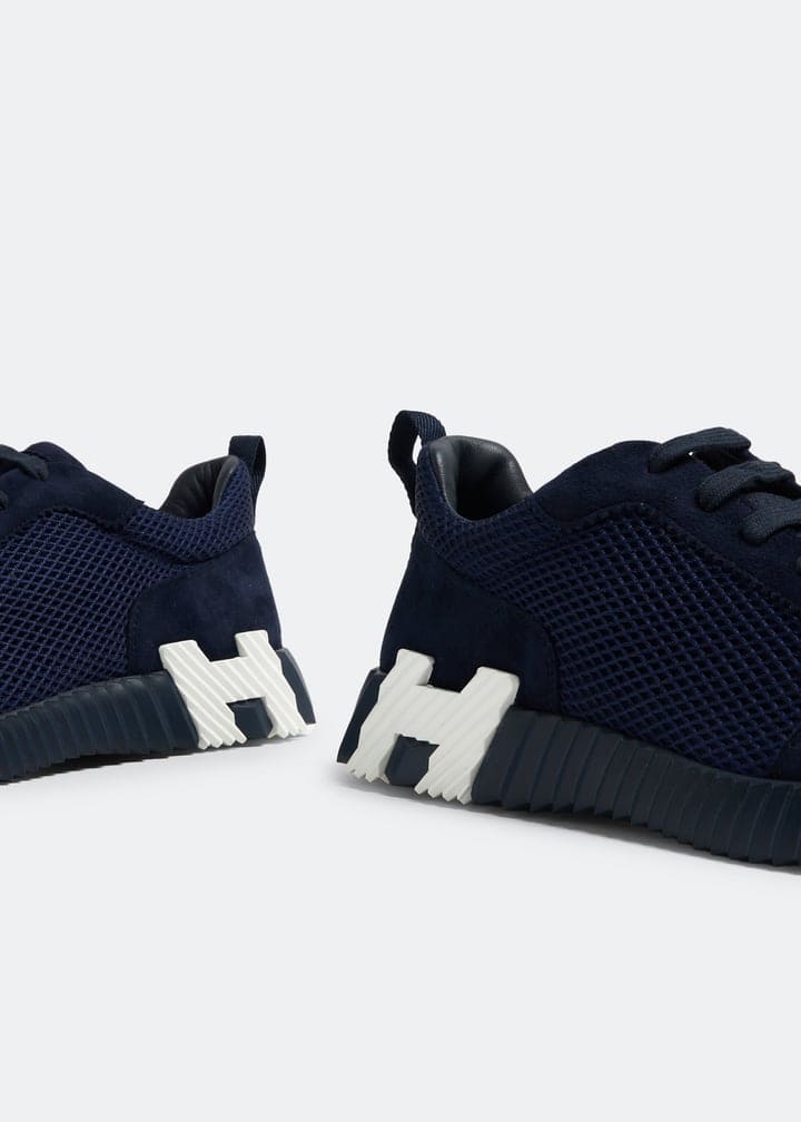 Stylish Hermès bouncing sneakers in black with white accents, perfect for casual and sporty looks.