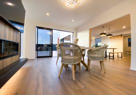 Bright modern dining area with natural light, inviting space for socialising and connection.